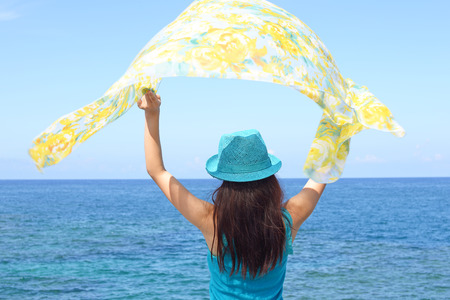 Young Asian woman on the beach enjoy sunlightの写真素材