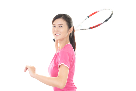 Smiling woman with a tennis racketの写真素材