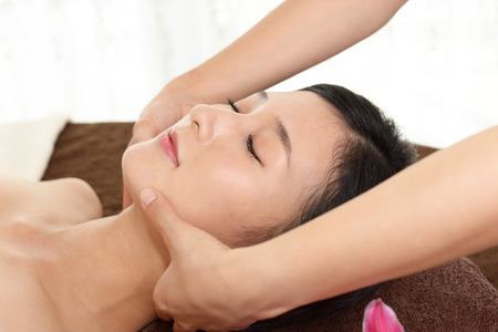 Woman getting a facial massageの写真素材