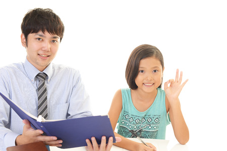 Smiling girl with teacherの写真素材