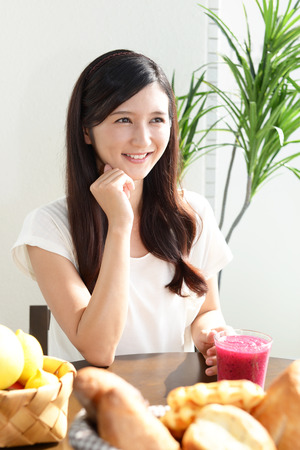 Woman drinking a glass of juiceの写真素材