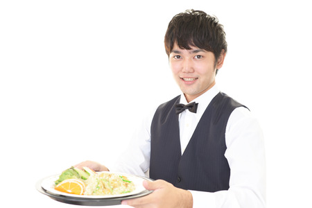 Smiling Asian waiterの写真素材