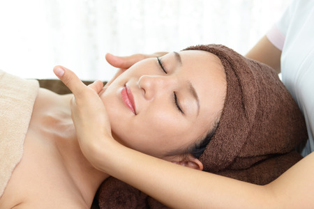 Woman getting a facial massageの写真素材