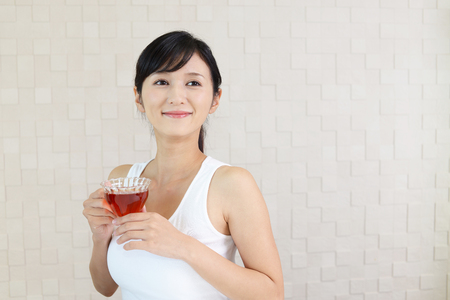Portrait of young woman drinking tea.の写真素材