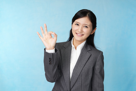Business woman with ok hand signの写真素材