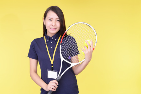 Smiling woman with a tennis racketの写真素材