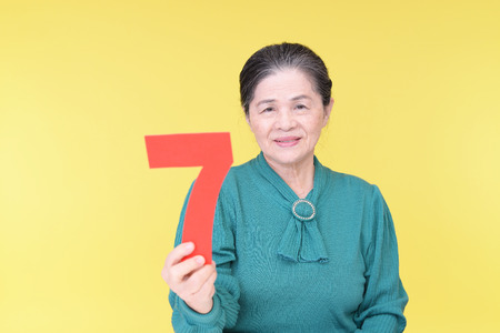 Old woman with a numberの写真素材