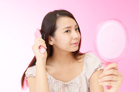 Beautiful woman brushing her hair