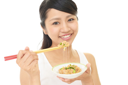 Woman who enjoys Japanese foodの写真素材
