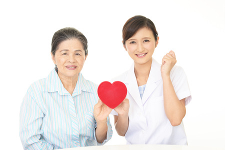 A friendly female doctor and an elderly womanの写真素材