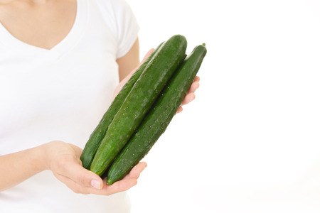 Woman holding cucumbersの写真素材