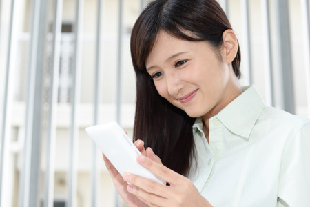 Woman with a smart phoneの写真素材