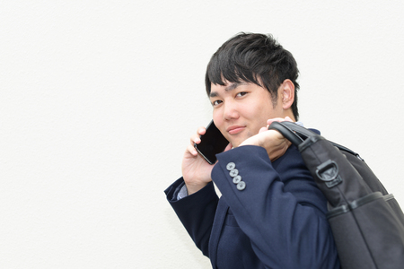 Man who is talking on a smart phoneの写真素材