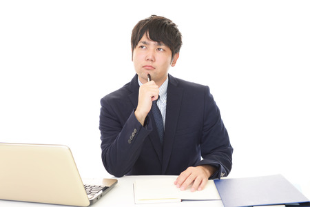 Tired and stressed Asian businessmanの写真素材