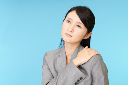 Business woman who has a shoulder pain.の写真素材