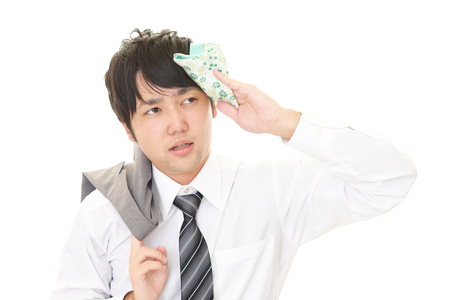 businessman wiping sweatの写真素材
