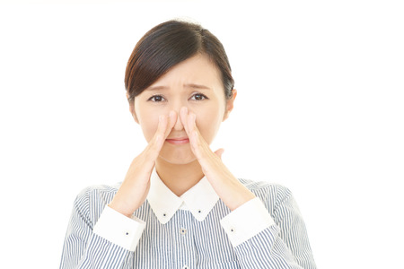 Woman covering her noseの写真素材