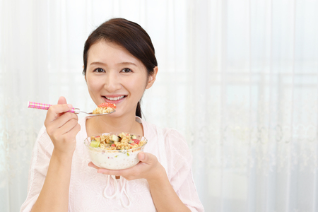Woman having breakfastの写真素材