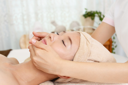 Woman getting a facial massageの写真素材