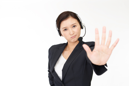 Call center operator making stop gestureの写真素材