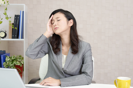 Business woman who has a headacheの写真素材