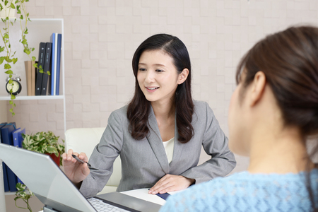 Smiling business woman with customerの写真素材