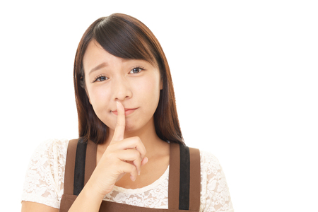 Woman placing finger on lips.の写真素材