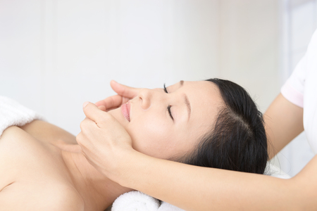 Woman getting a facial massageの写真素材
