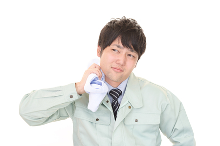 Tired and stressed Asian workerの写真素材