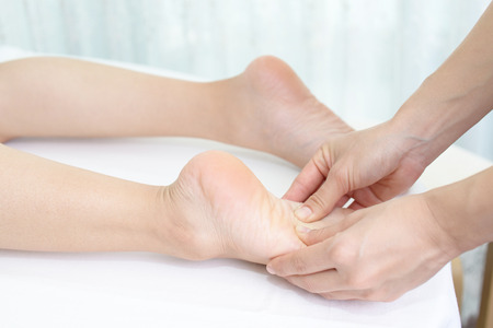Close-up of feet receiving massage in spaの写真素材
