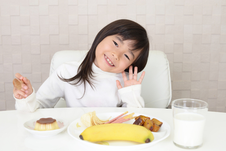 Happy girl with foodsの写真素材