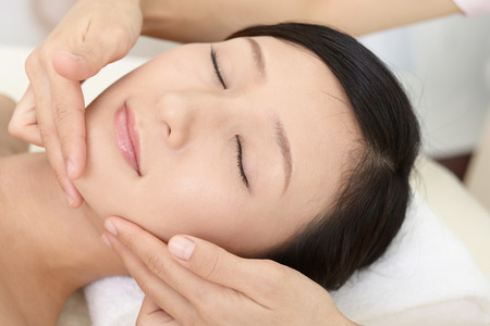 Woman getting a facial massageの写真素材