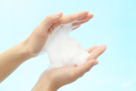 Foam of soap and female hands Foam of soap and female hands