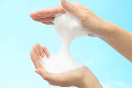 Foam of soap and female handsの写真素材