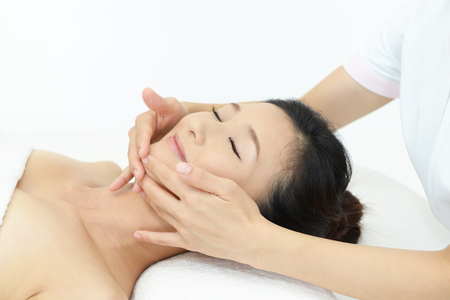 Woman getting a facial massageの写真素材