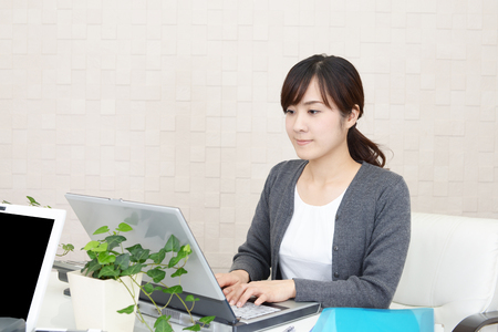 Business woman working on a laptopの写真素材