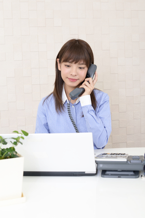 Business woman with a phoneの写真素材