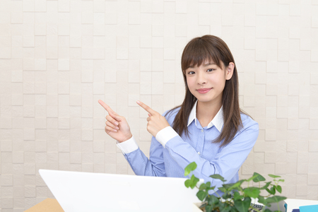 Business woman pointing with her fingersの写真素材