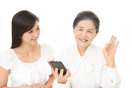 Smiling old woman and young ladyの写真素材