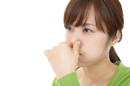 Woman pinches her noseの写真素材