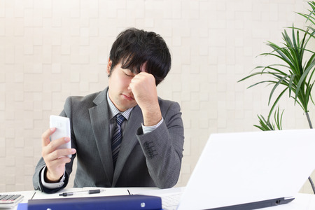 Tired Asian businessmanの写真素材