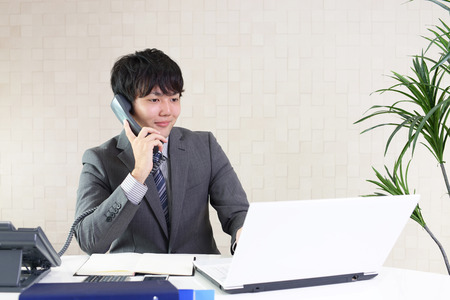 Businessman with a phoneの写真素材