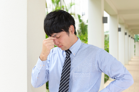 Tired Asian businessmanの写真素材