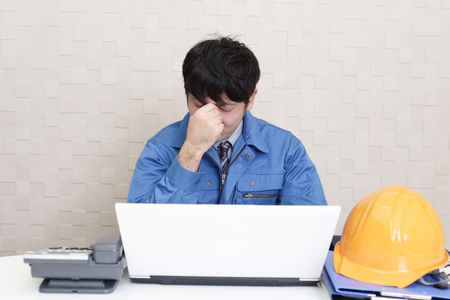 Tired Asian workerの写真素材