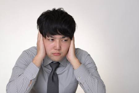 Man who holds his earsの写真素材