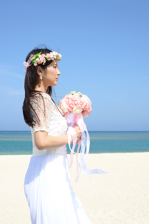 Beautiful young woman in white dressの写真素材