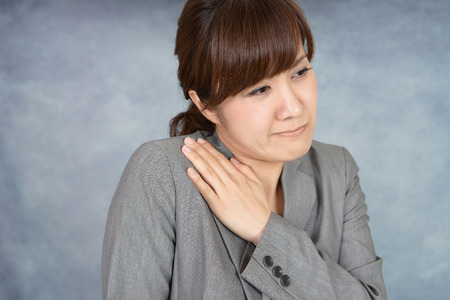 Business woman who has a shoulder pain.の写真素材