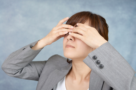 The woman with eyestrainの写真素材