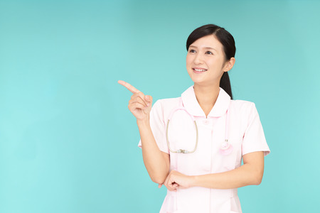 Young female nurse pointingの写真素材