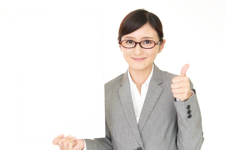 Smiling business woman with a whiteboardの写真素材